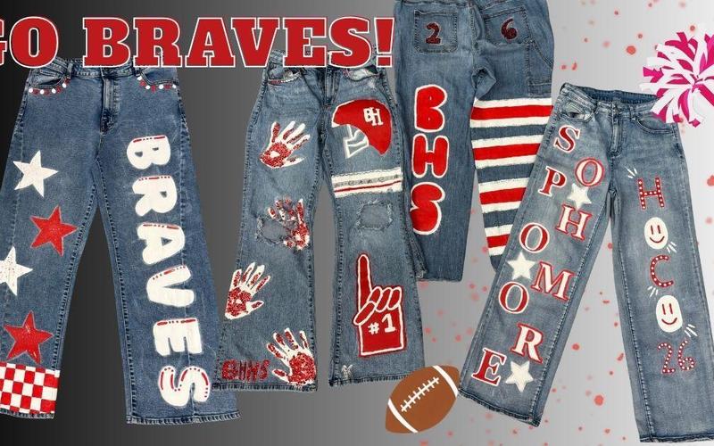 Decorated jeans featuring school spirit designs and slogans related to 'Braves.'
