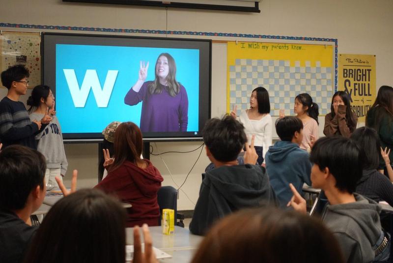 Students in ASL club practice signing