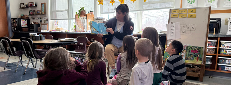 Superintendent reading to children in classroom