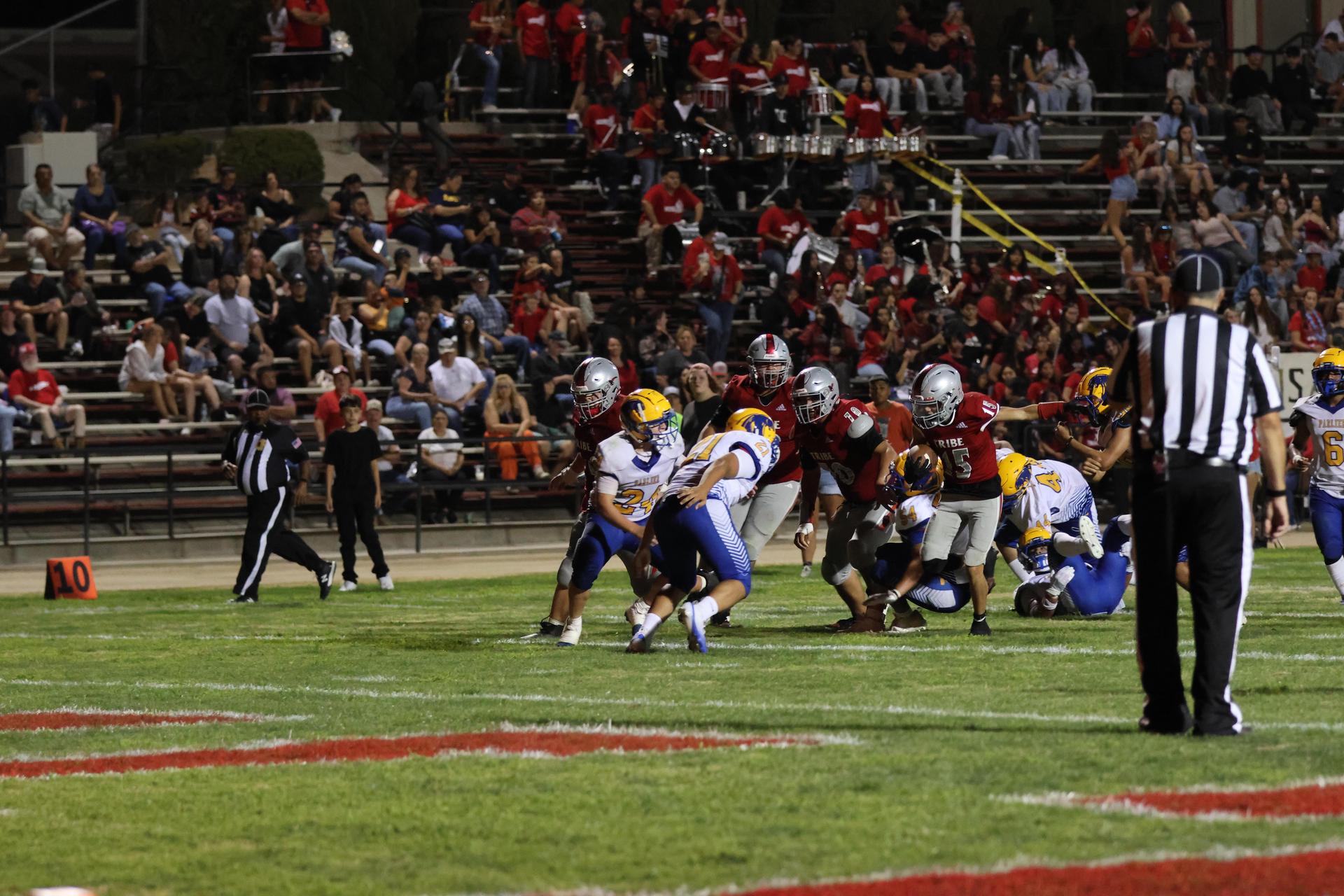 Varsity football players in action against Parlier 59