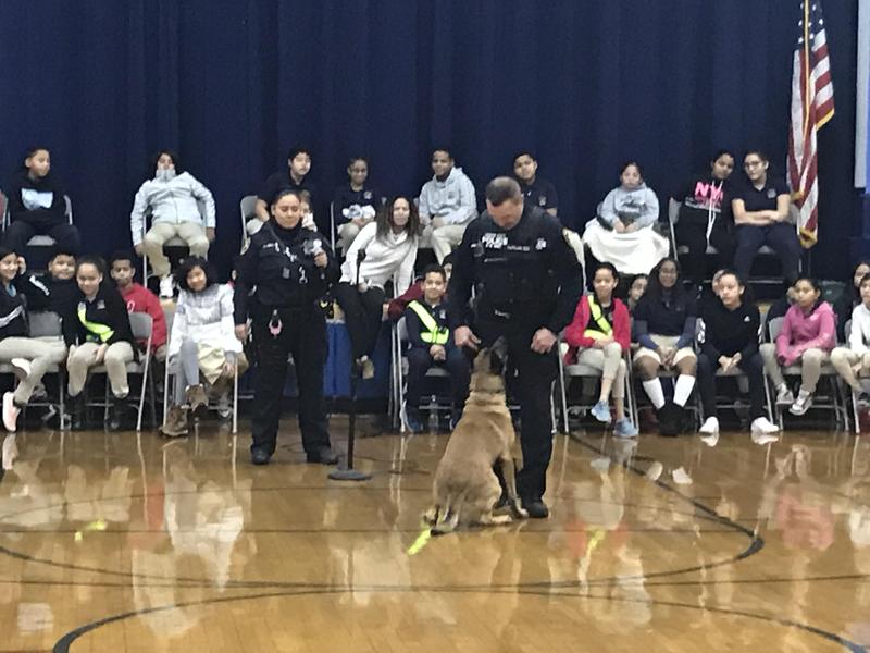 UC police officers with the dog sitting in the assembly