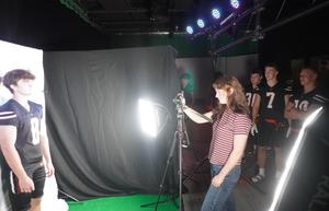 A student is interviewed and filmed in a digital media studio.