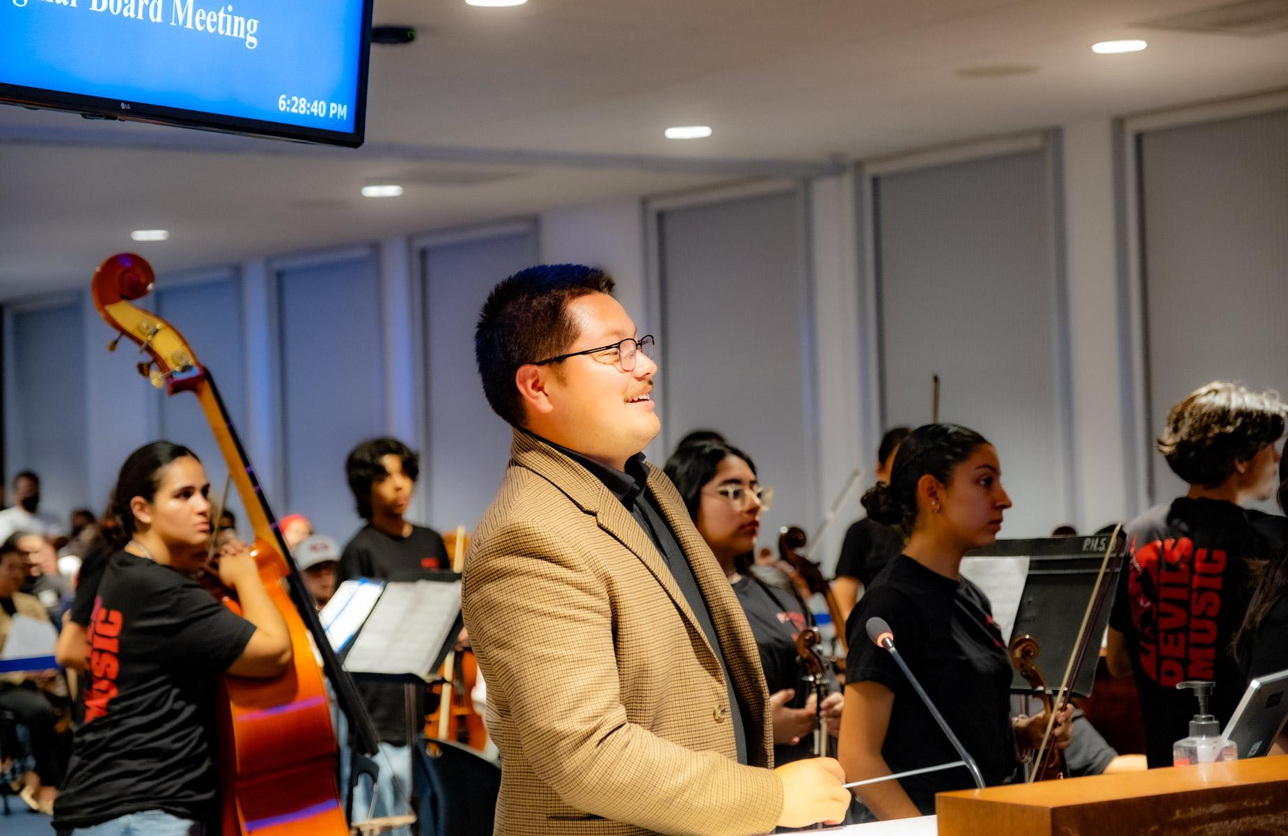 Band teacher addressed school board at speaking booth
