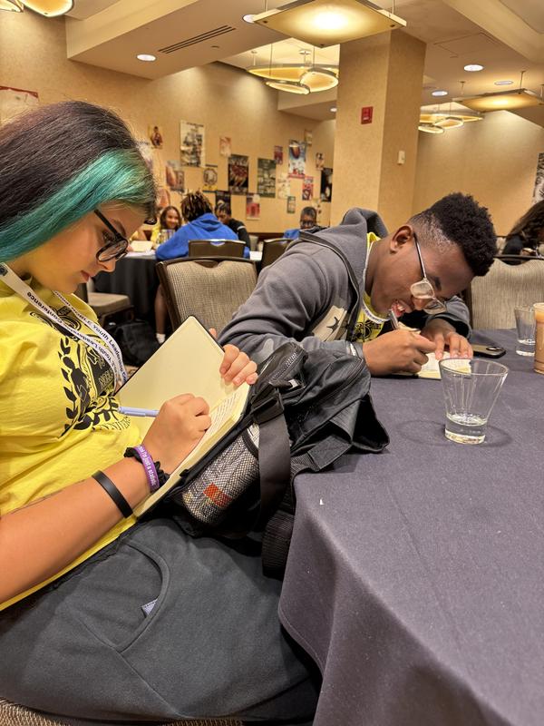 Emmalee writes in a notebook