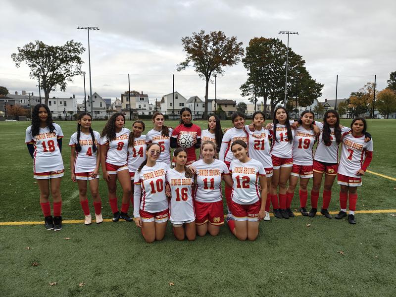 girls soccer team standing together at field