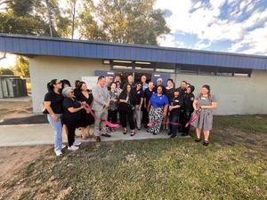 Ribbon cutting ceremony with attendees