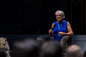 Denise Sedlacek speaks to the staff