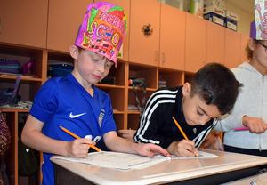 Students completing reading and math activities.