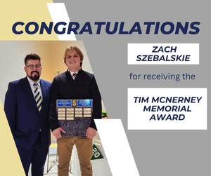 teen holding a large plaque award standing beside coach