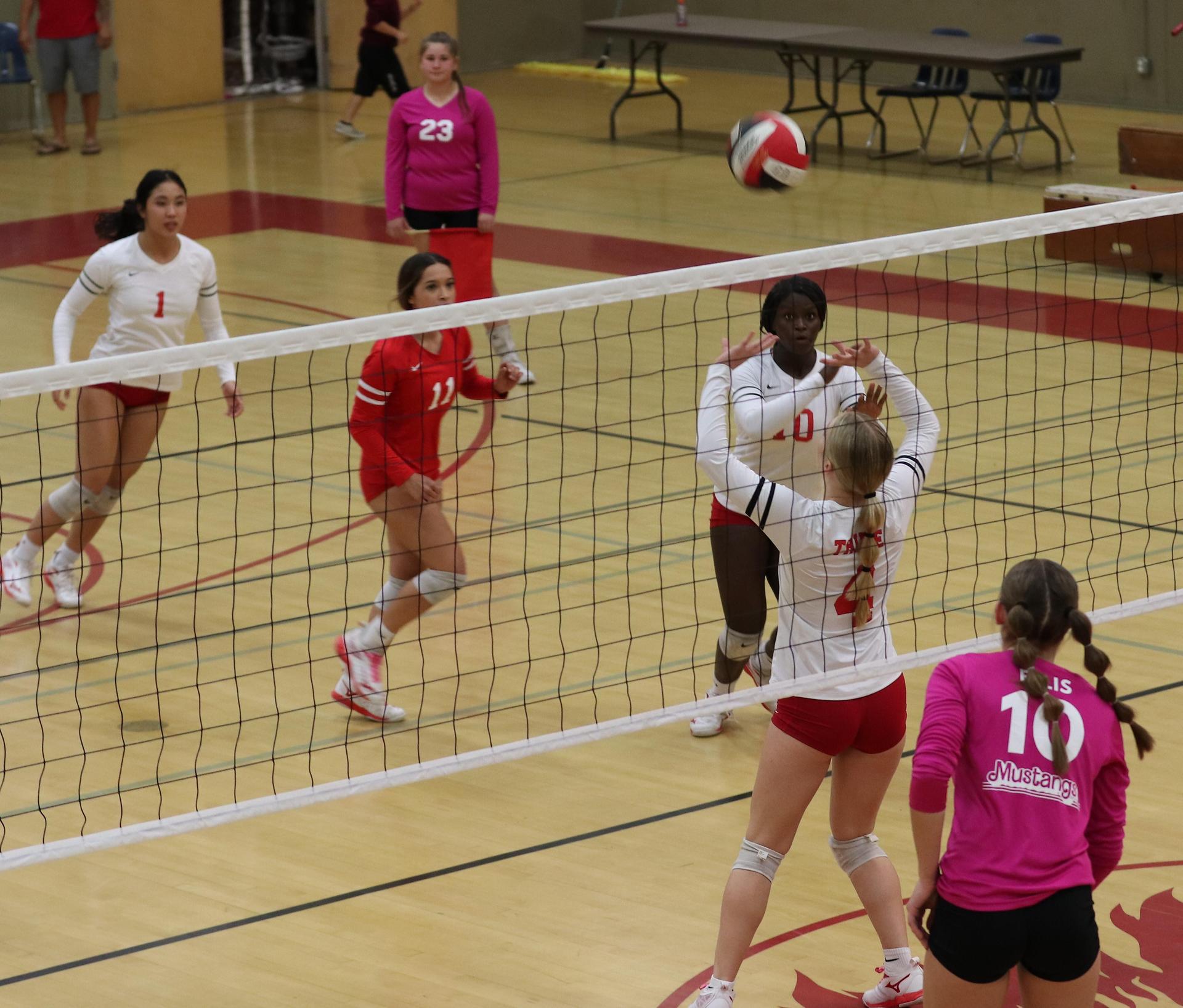 varsity volleyball players in action against Minarets