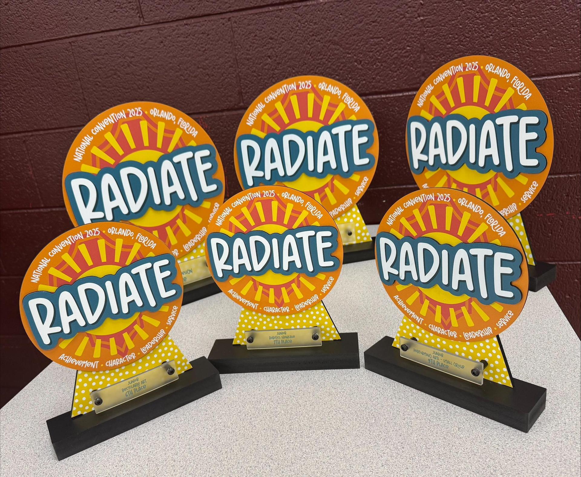 Six trophies that say Radiate. 