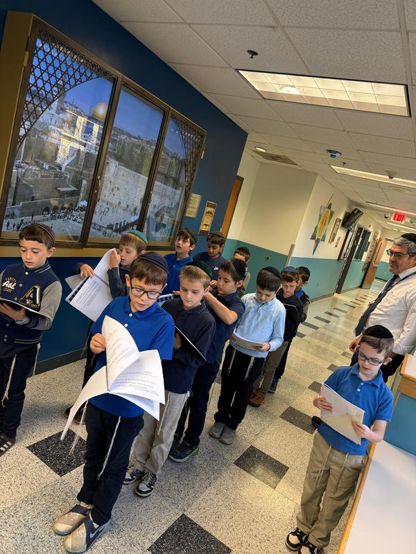 The third grade boys davening in front of the Kosel