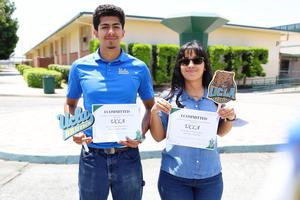 Two students hold UCLA commitment certificates and UCLA-themed signs during a college commitment day event.
