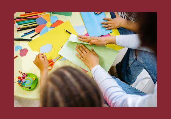 kids hands shown at table with coloring crayons and paper