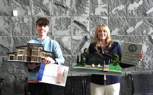 Two students show their  architectural models taken to the state MITES.