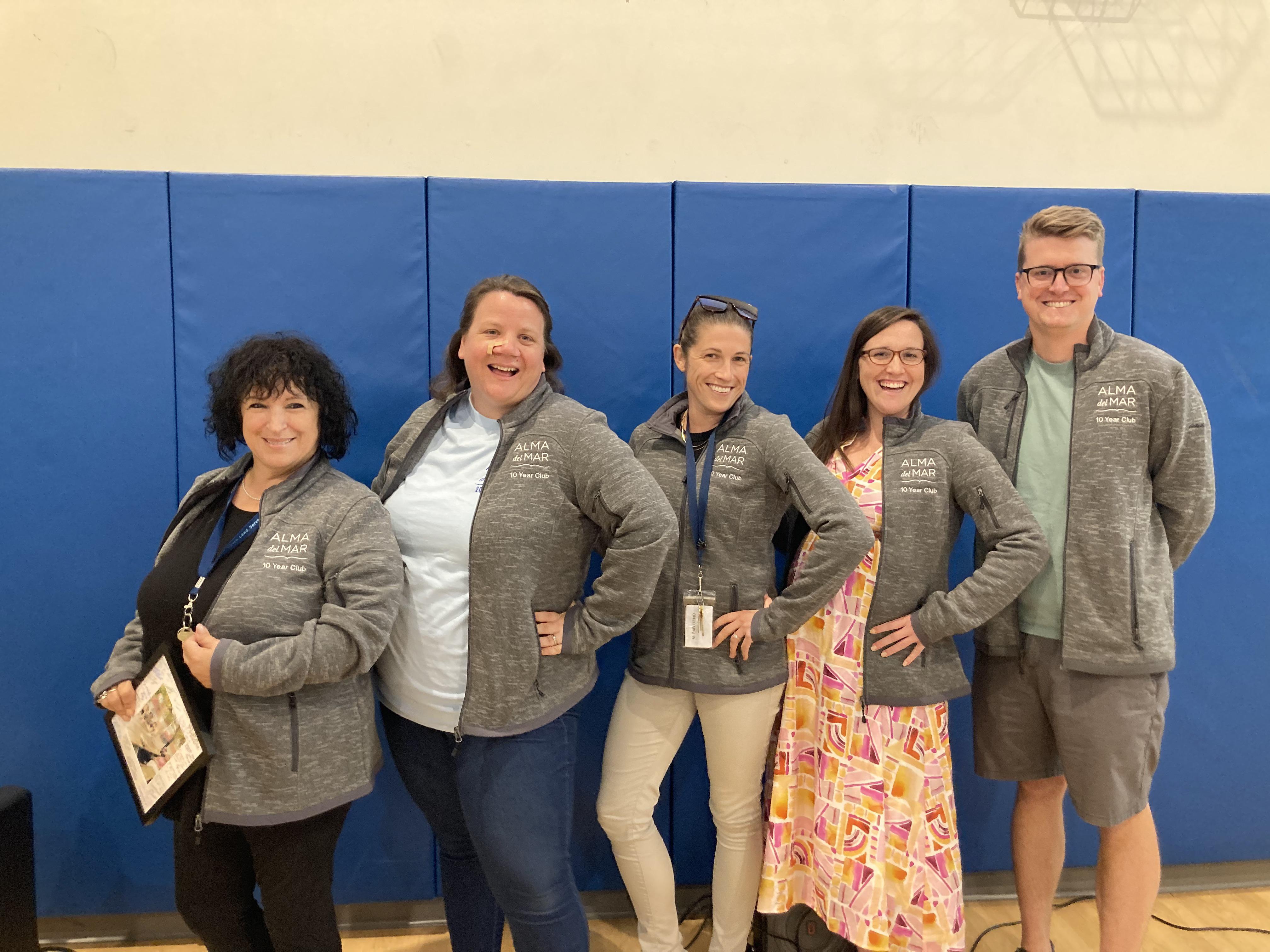 Staff pose after receiving an award for 10 years of service at Alma del Mar.
