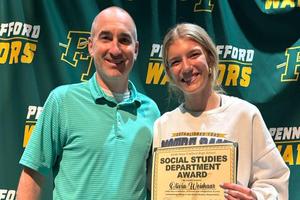 Social Studies teacher Mr. Matt Bilinsky presents the department award to Olivia Weishaar