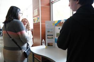 IB students present their research project to a community member