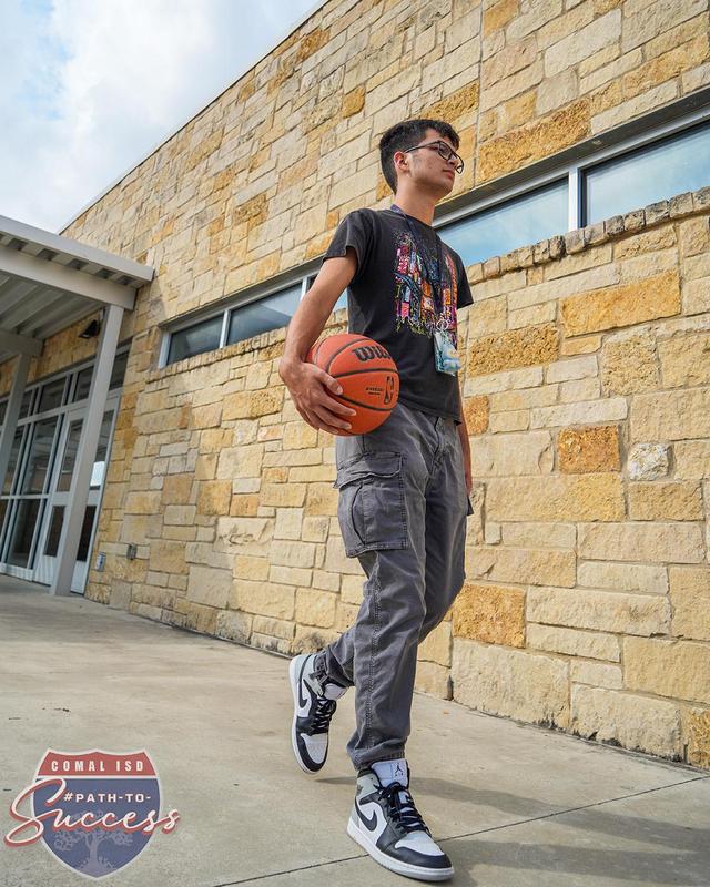 MECHS Senior Jake Hernandez walking to the basketball court at MECHS.