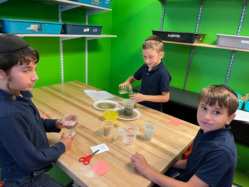 Three boys do a water-gas experiment.