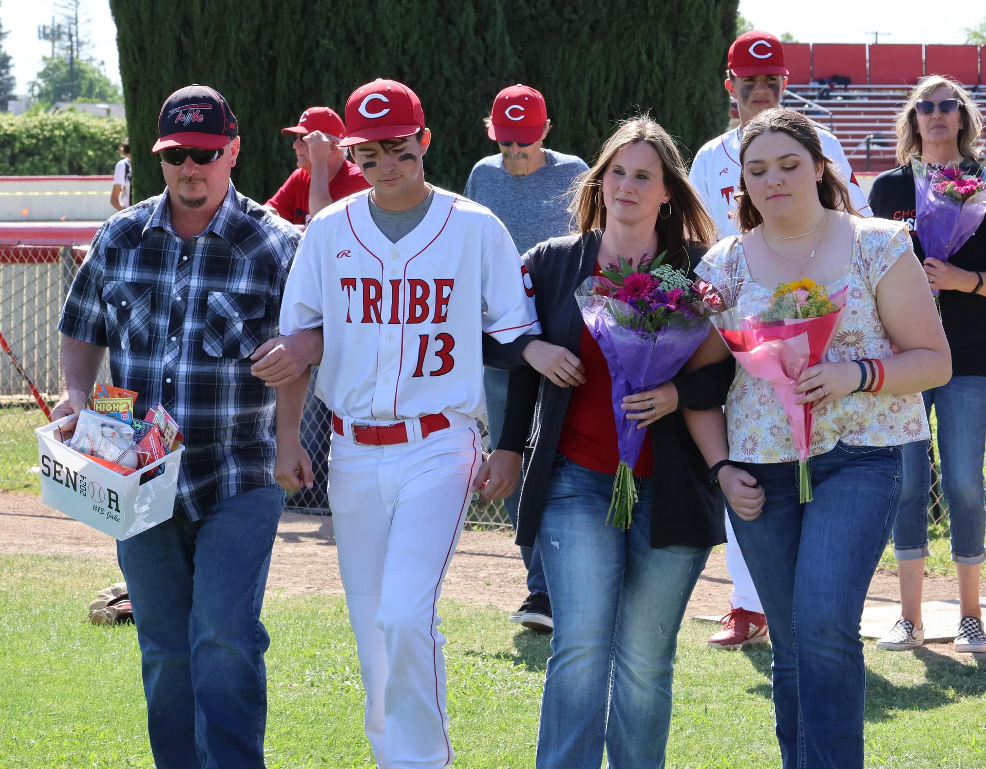 Seniors Posing With Teammates, Coaches, And Family