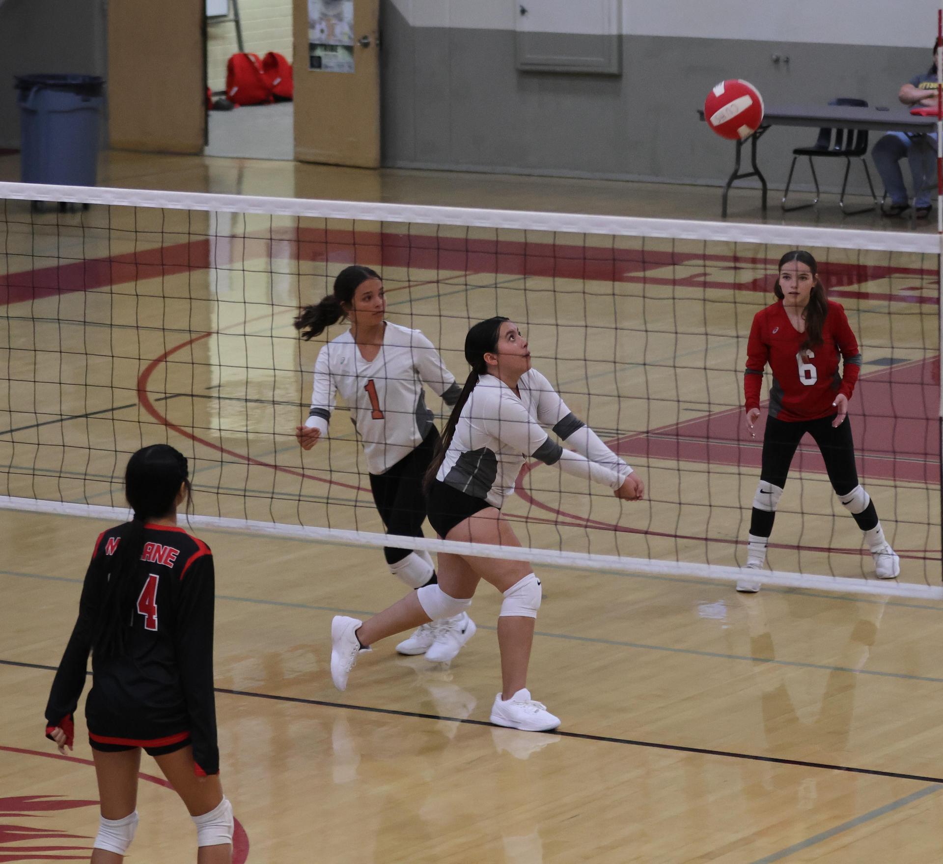 junior varsity girls playing volleyball 122