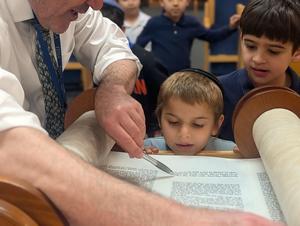 Boy looking at torah