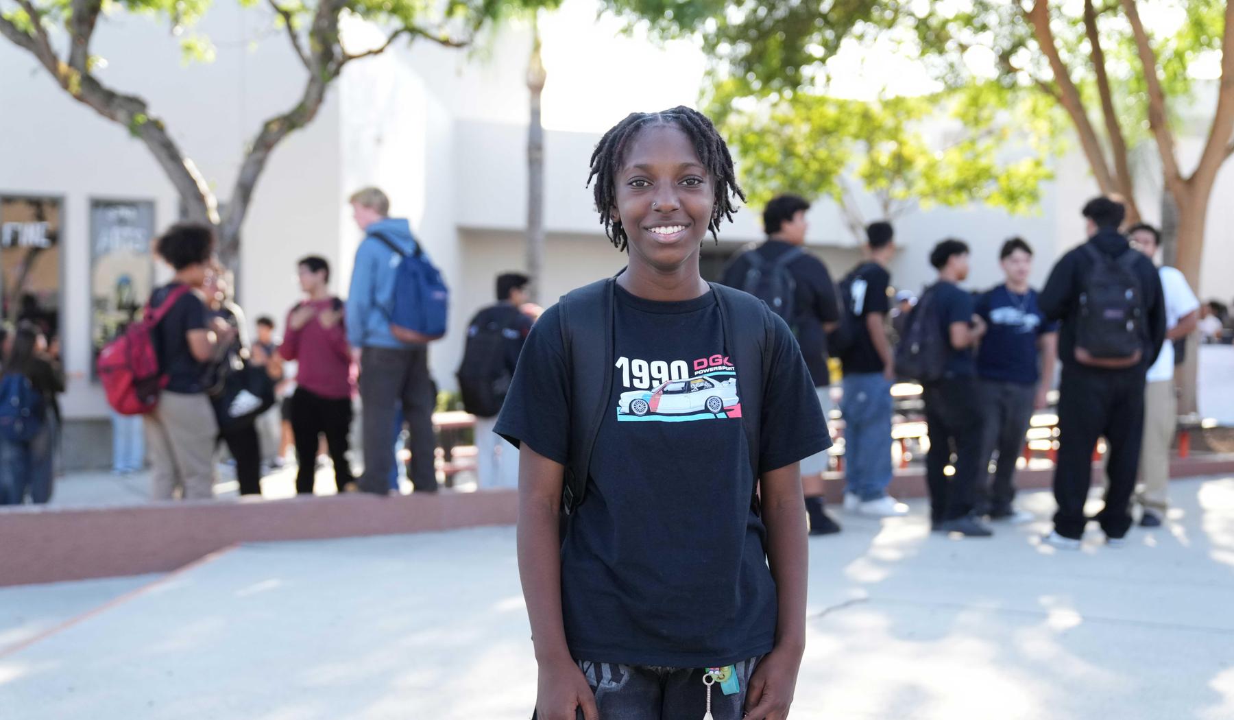 smiling girl standing in the SJHS Quad