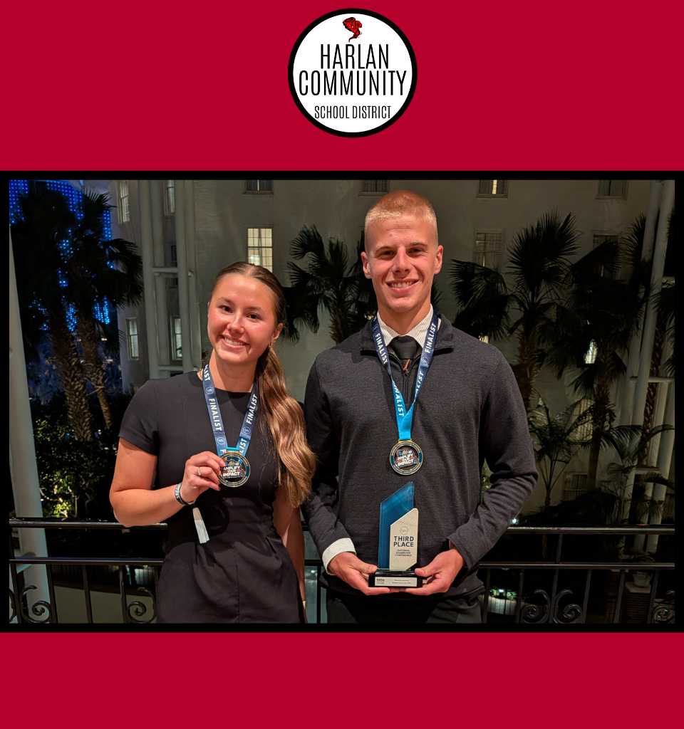 Two students holding awards at a formal event.