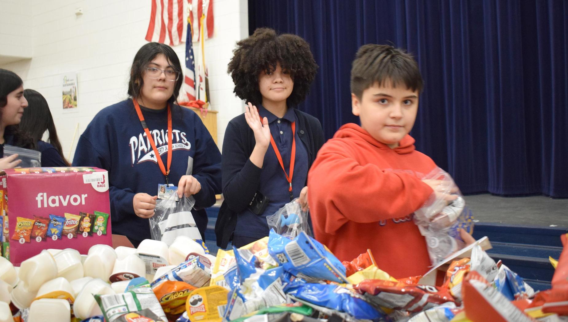 Students participating in an event with snacks and patriotic decorations.
