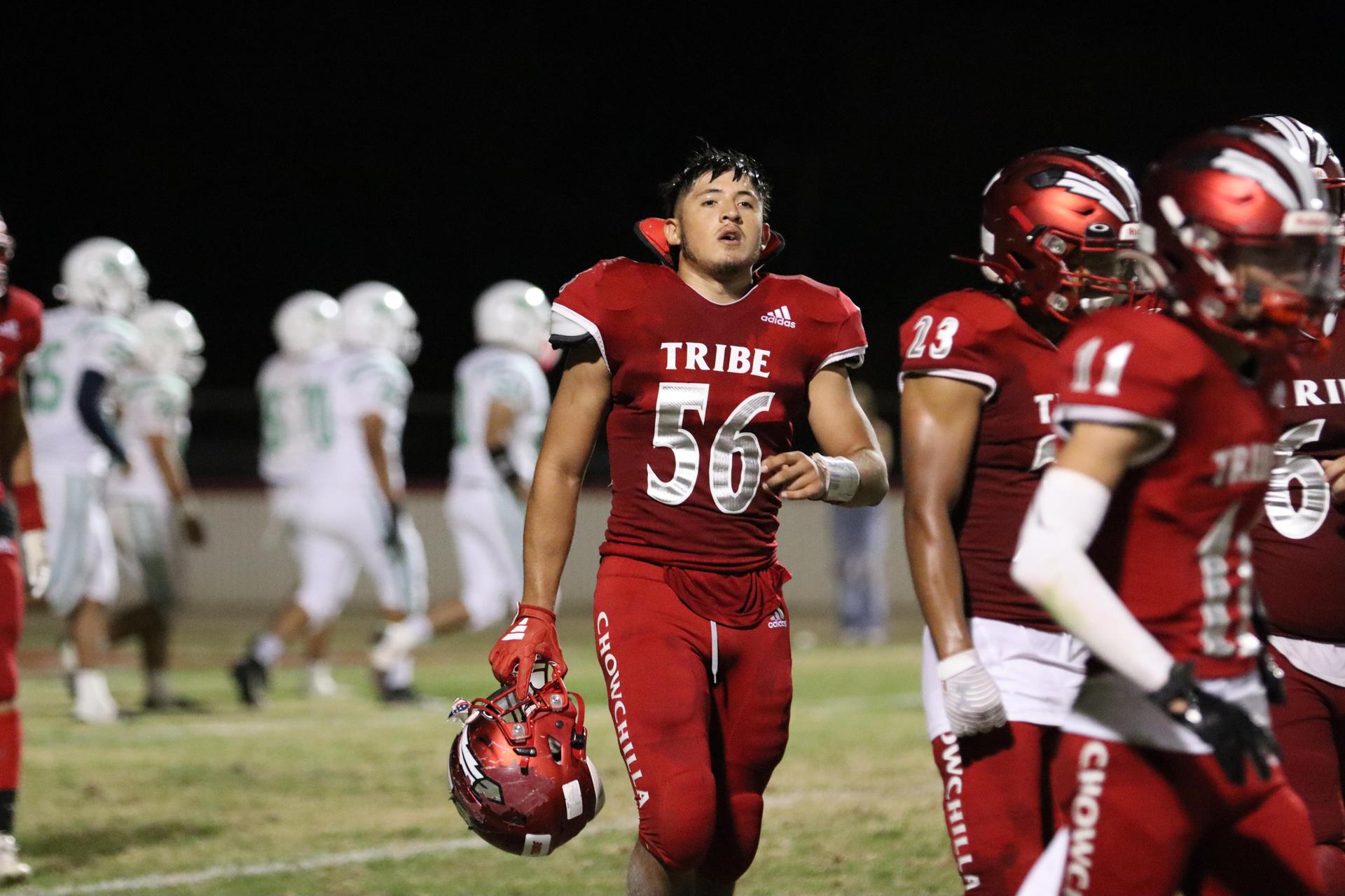 varsity football players in action against Riverdale