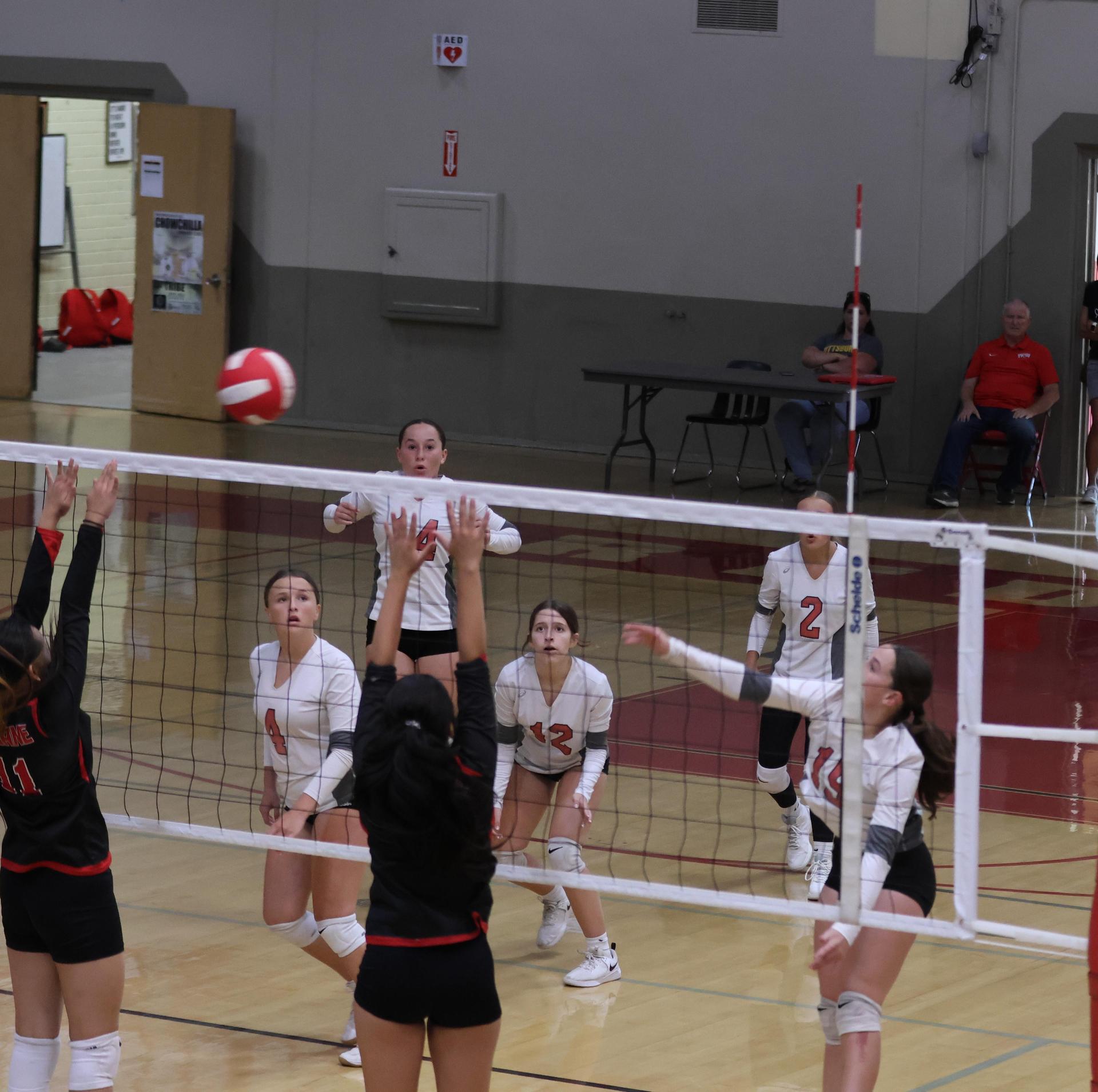 junior varsity girls playing volleyball 99