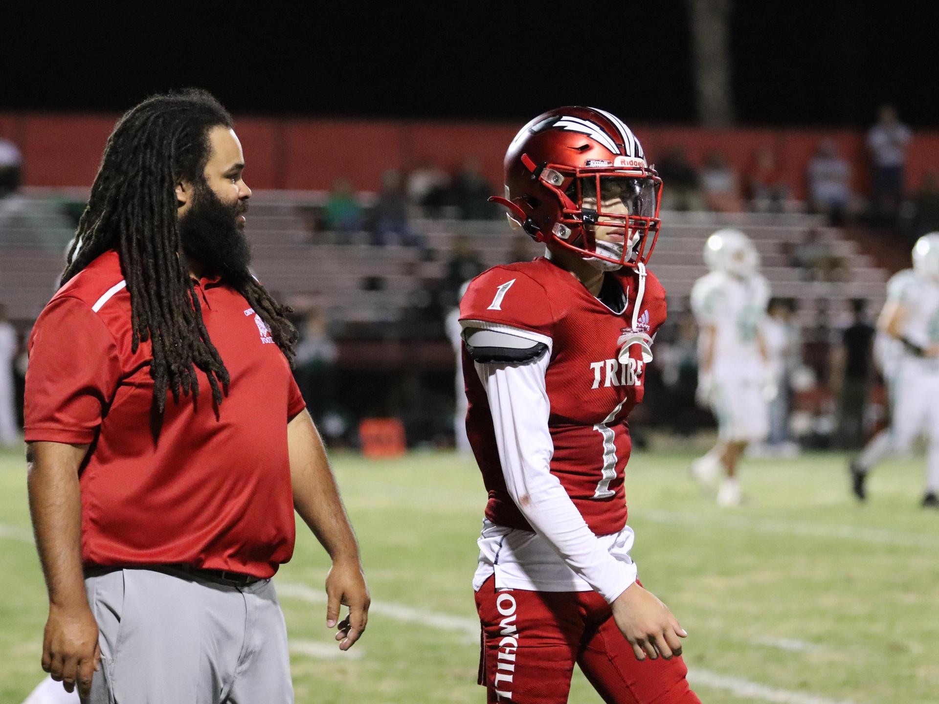 varsity football players in action against Riverdale