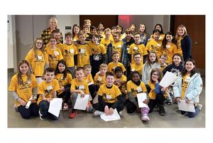 a large group of students wearing yellow t-shirts