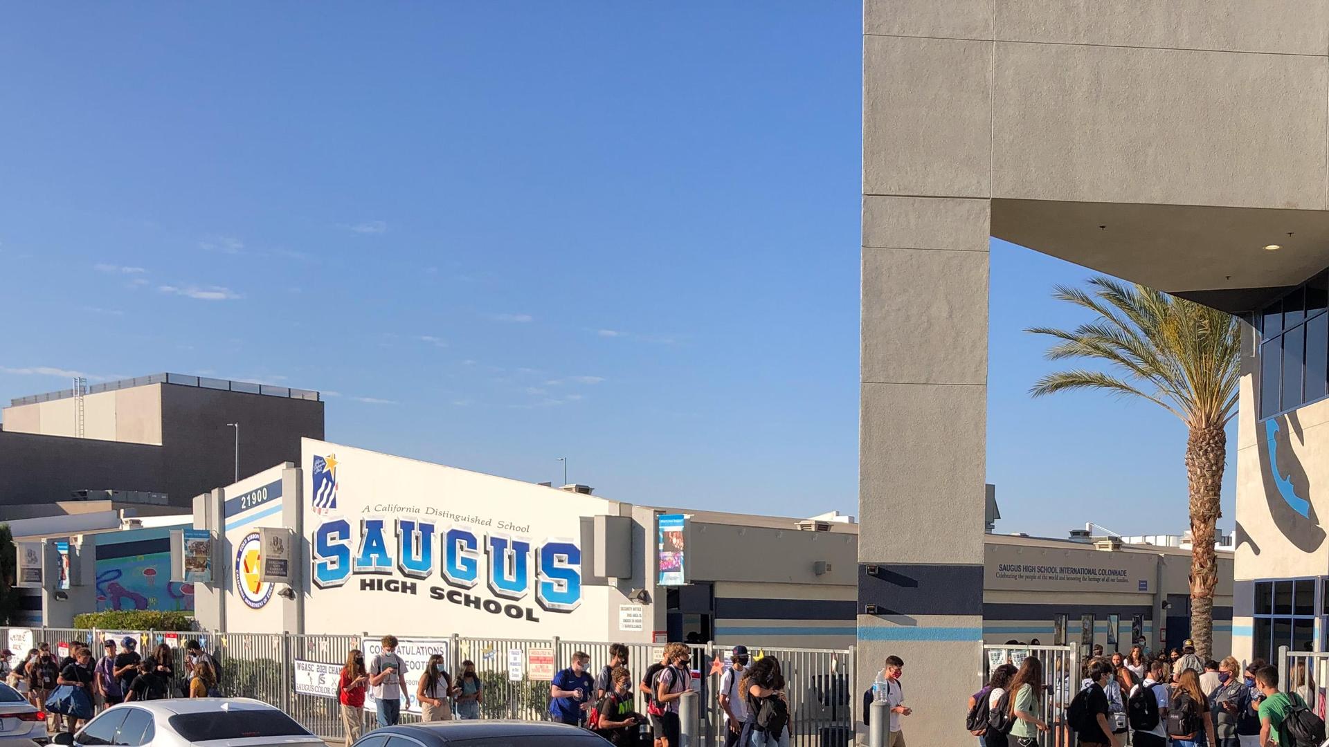 Saugus High School exterior with groups of students arriving for classes.