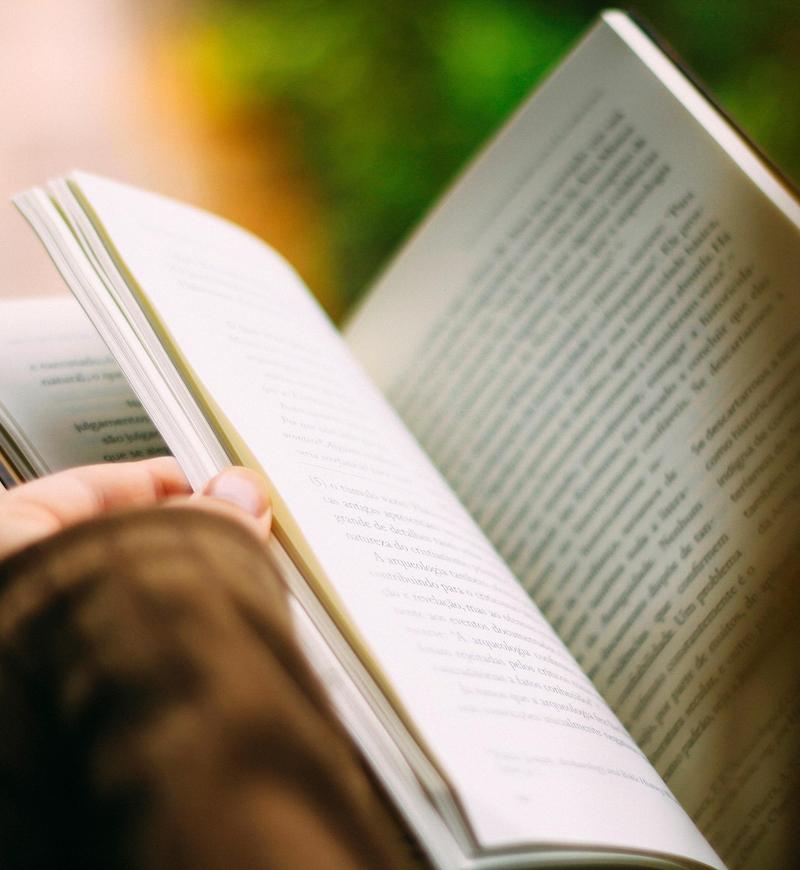 Hands holding open a book