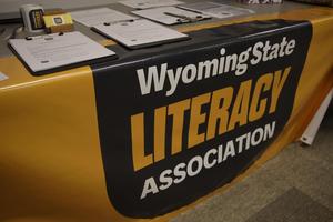Table with the Wyoming State Literacy Association logo