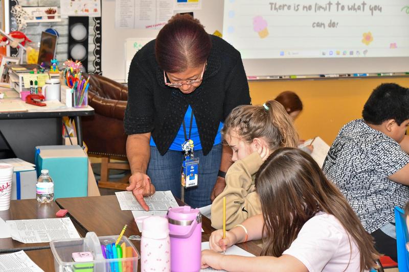 Woman helping student with activity