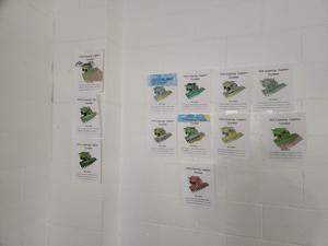 Coloring contest entries hanging on a wall.