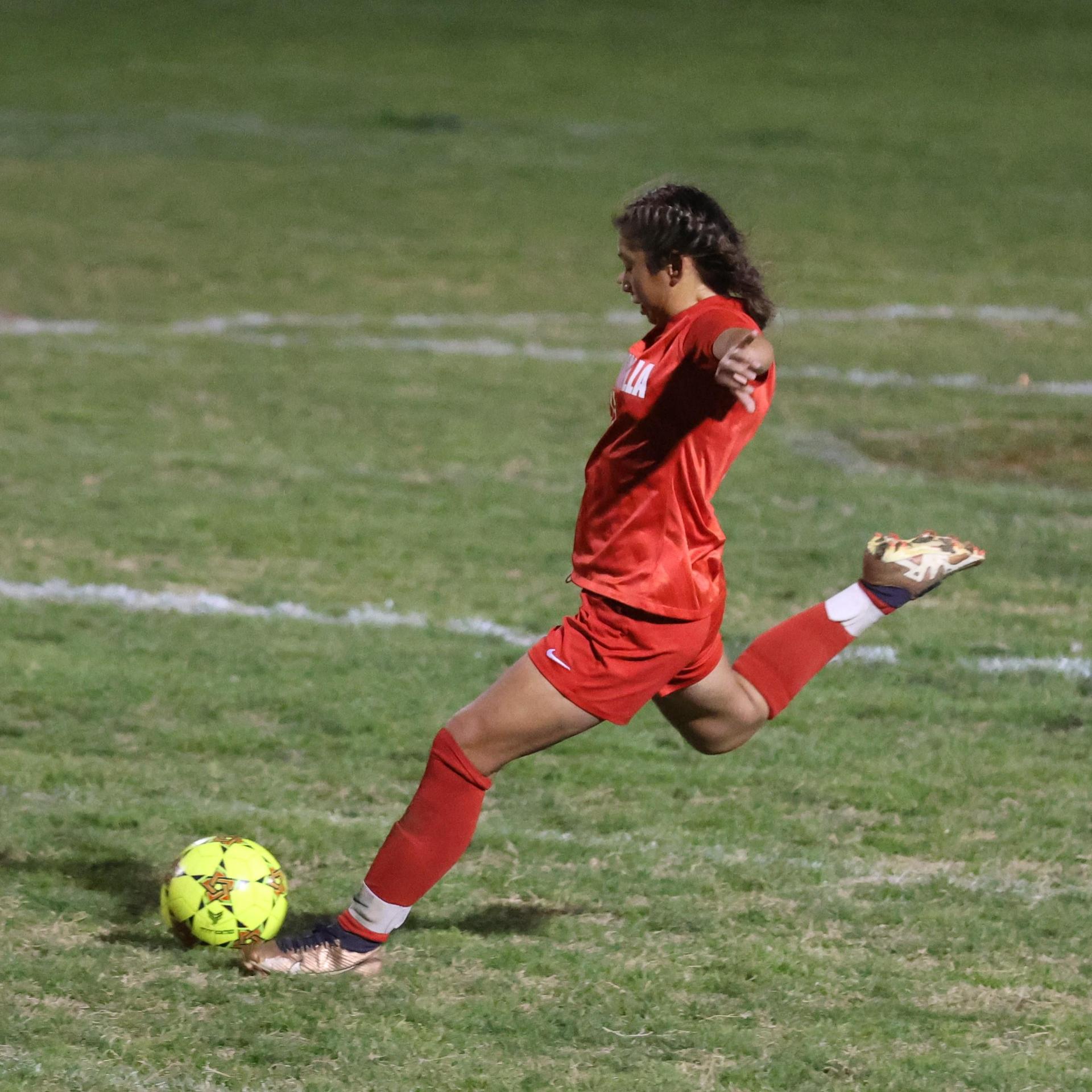 Varsity girls playing soccer against sunnyside