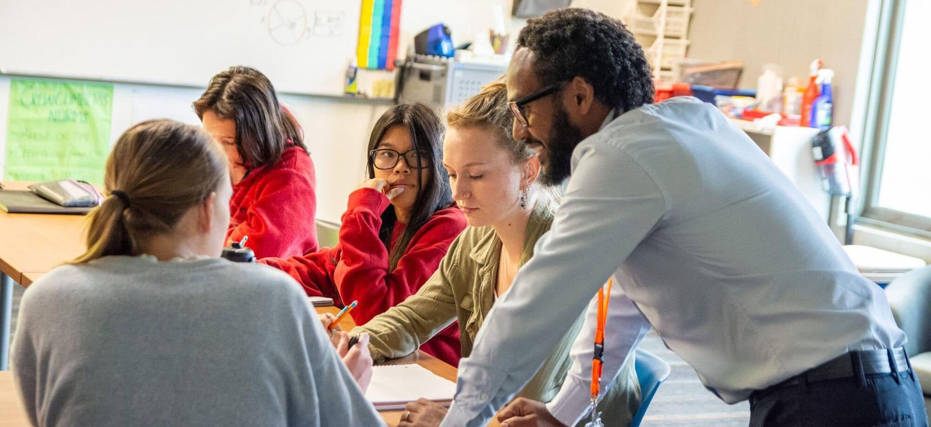 High school students being instructed by a math teacher