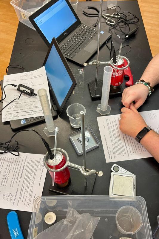 scientific equipment and laptops scattered across a work table at tuition-free charter public school Harbor City International School