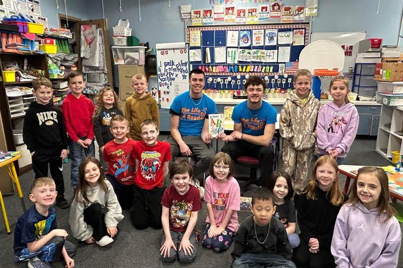 Seniors Zach Feldman and Tyler Boss visit Mrs. Linda Kelly’s first-grade class at Sunrise Elementary School to read Dr. Seuss’s ABC to the students