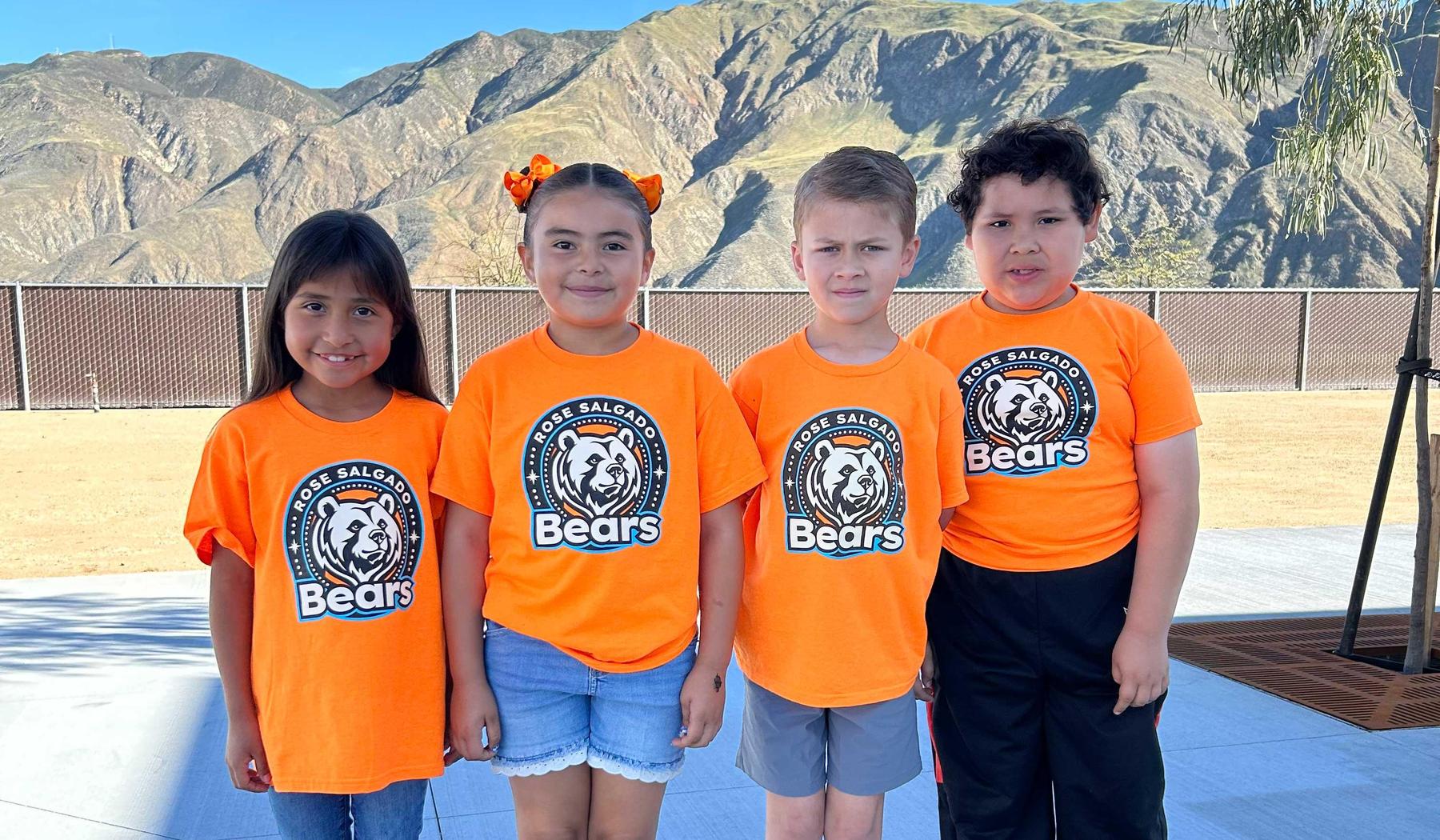 4 students in orange Rose Salgado Elementary shirts