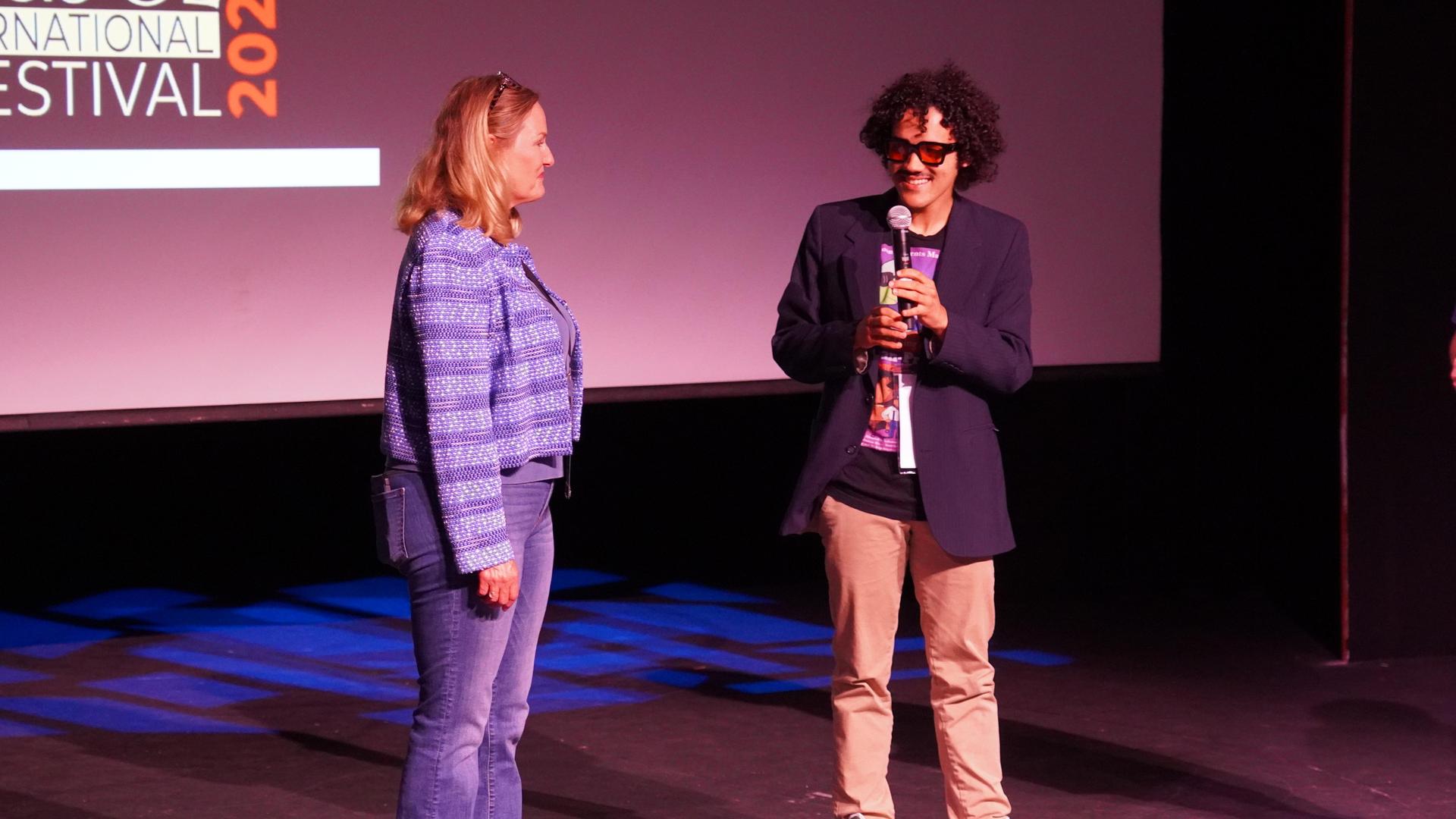 Solomon Sloan on stage and speaking