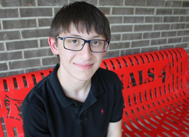 Picture of Riley Sheridan on bench outside Mayfield High School