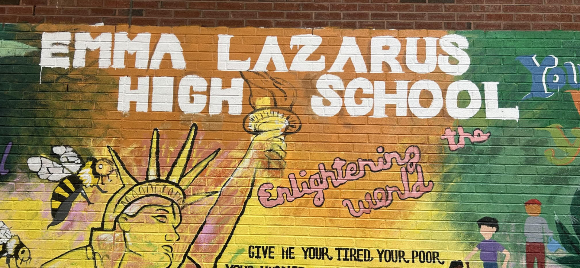 Mural featuring Statue of Liberty and text about enlightenment and acceptance.