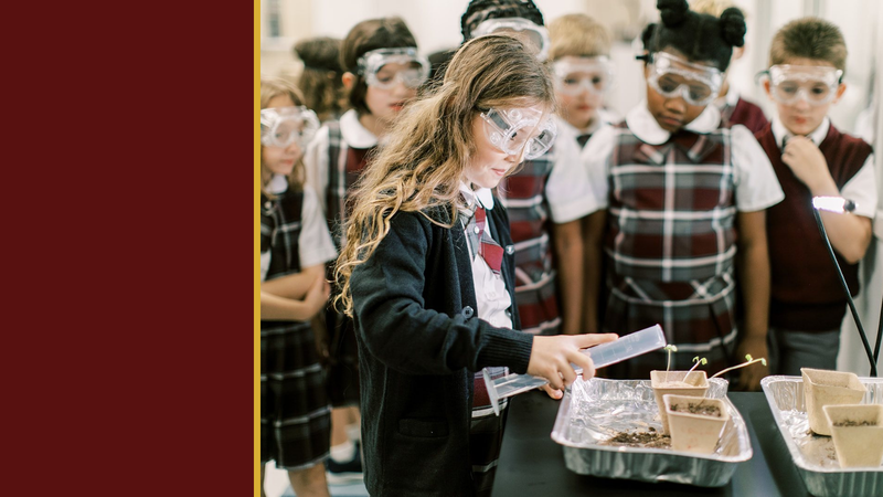 Students in safety goggles work together on a science activity