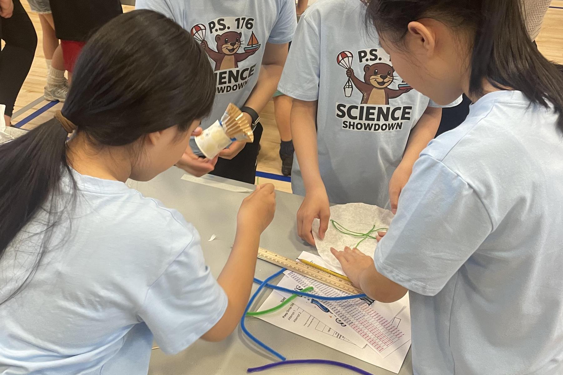 Students working together on a science experiment using materials.