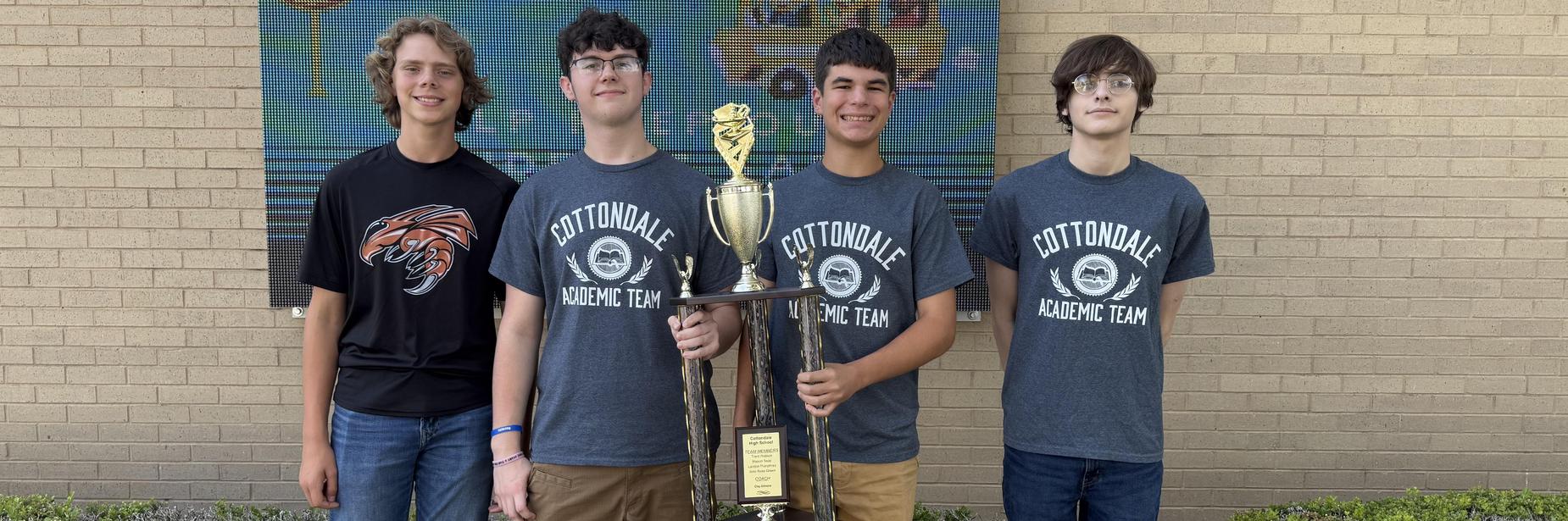 academic team mebers with trophy